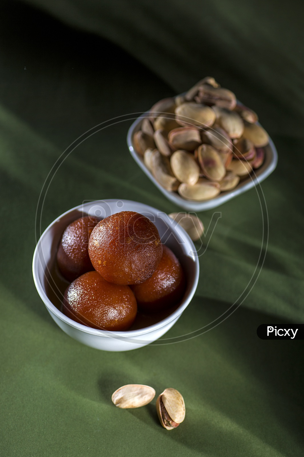 Indian Dessert or Sweet Dish Gulab Jamun in a Bowl with Almond and Pistachio