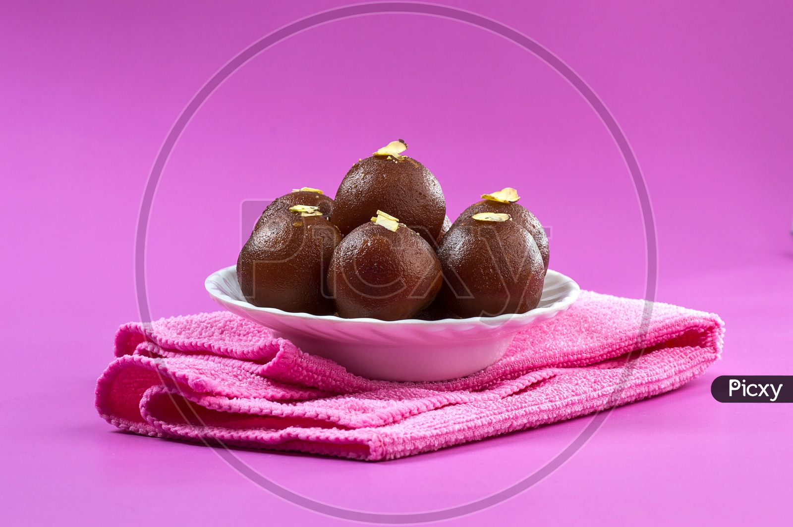 Image Of Indian Dessert Or Sweet Dish Gulab Jamun Topped With Pistachio image-of-indian-dessert-or-sweet-dish-gulab-jamun-topped-with-pistachio