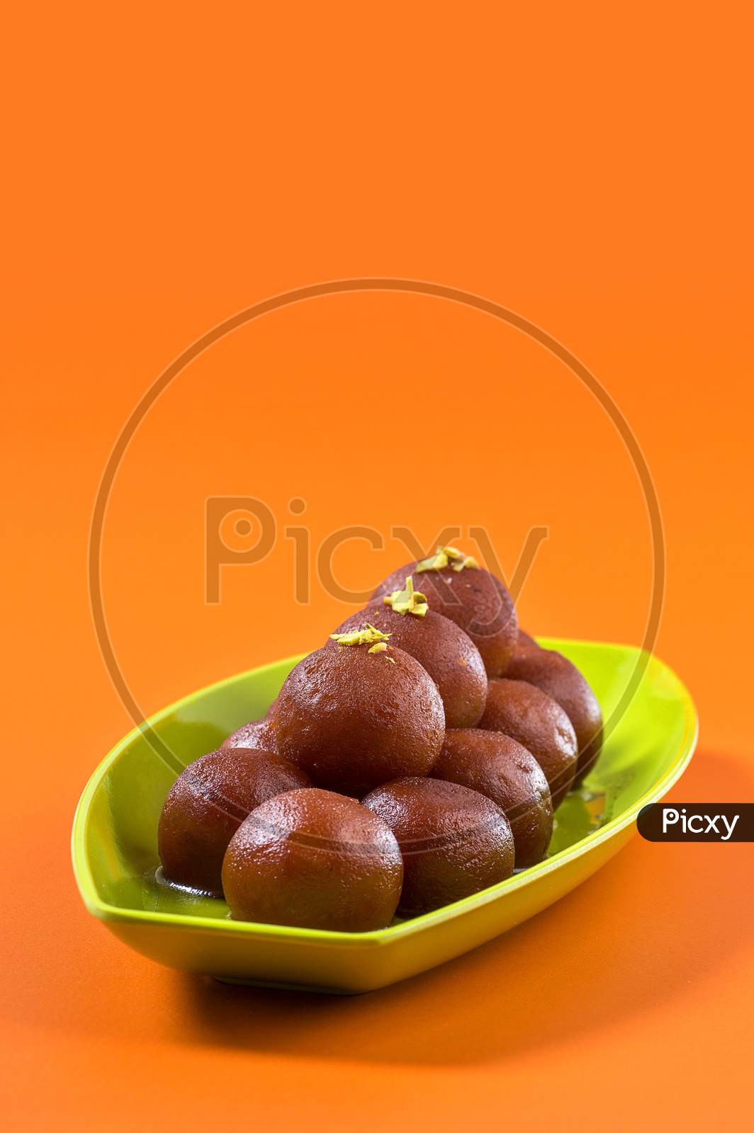 Image of Indian Dessert or Sweet Dish Gulab Jamun topped with Pistachio ...