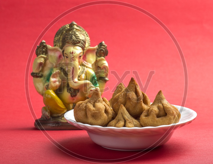 Indian Food Modak with Lord Ganesha Idol, Maharashtra Sweet Dish