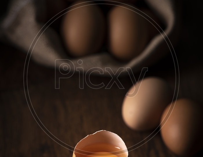 fresh eggs in a basket on wooden table
