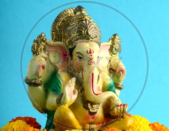 Hindu God Ganesha or Ganapathi. Lord Ganesha Idol on Blue Background