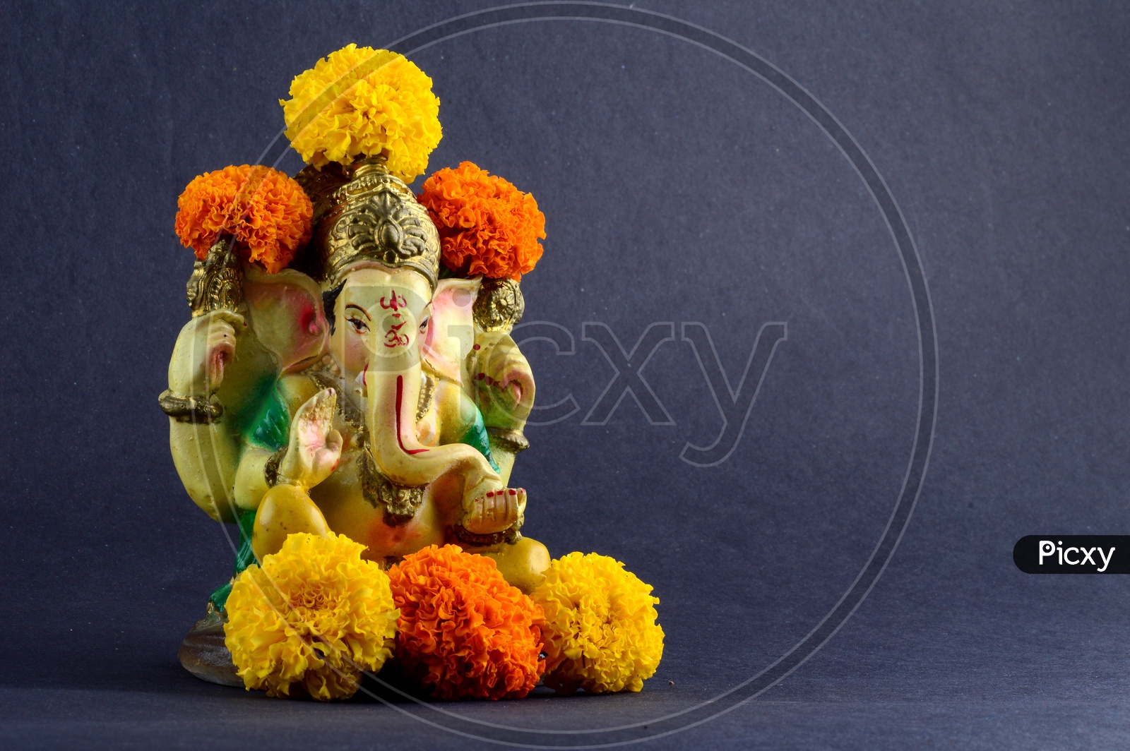 Hindu God Ganesha or Ganapathi. Lord Ganesha Idol on grey Background