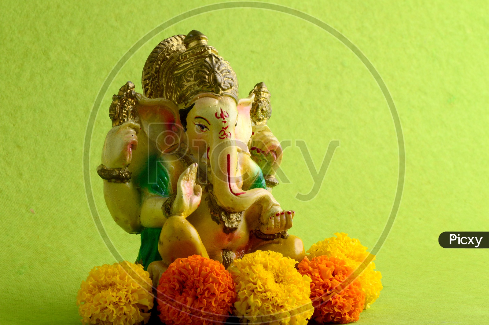 Hindu God Ganesha or Ganapathi. Lord Ganesha Idol on Green Background