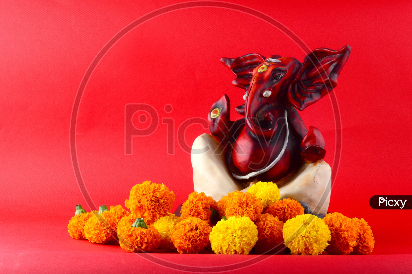 Hindu God Ganesha or Ganapathi. Lord Ganesha Idol on Red Background