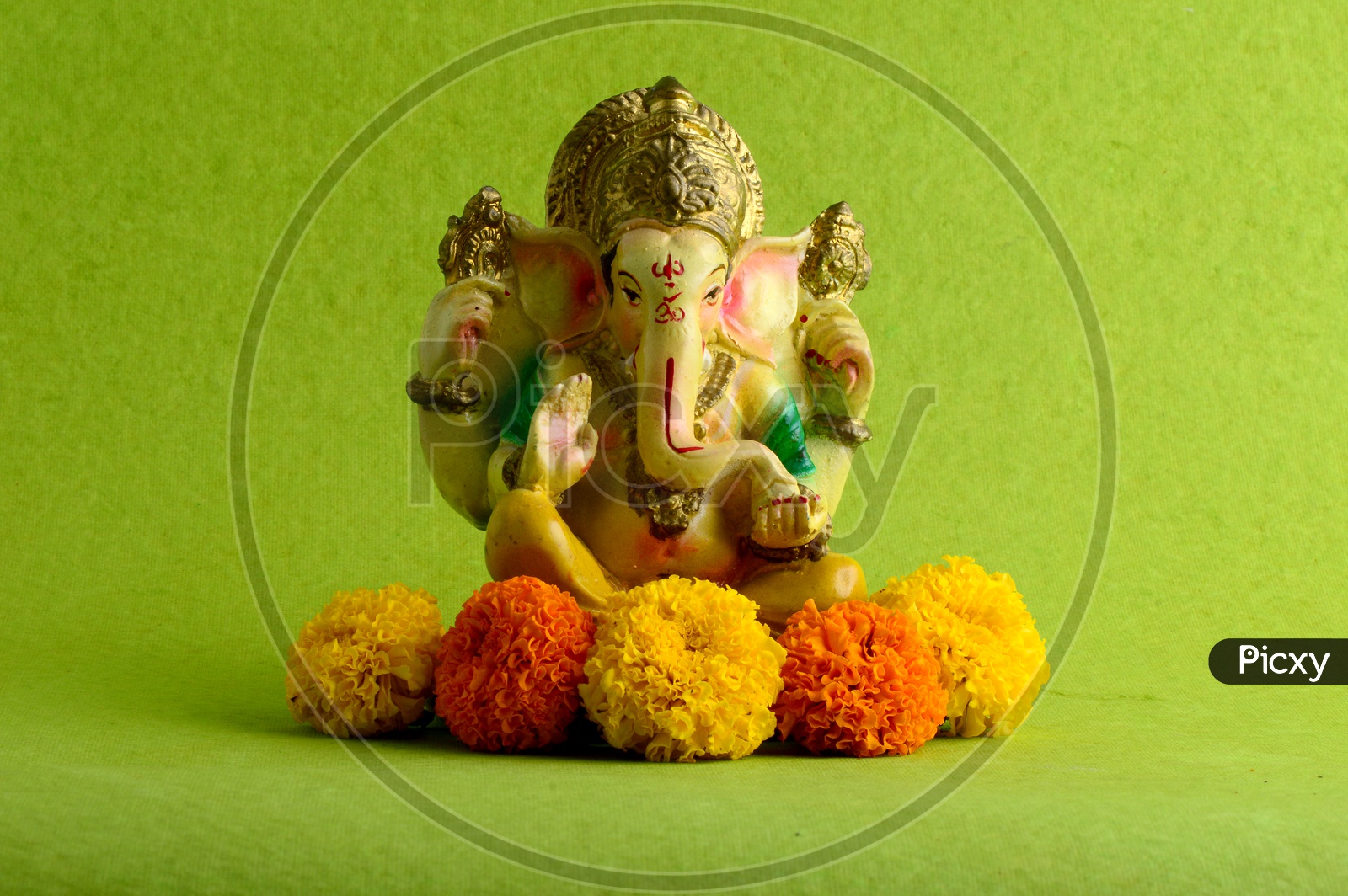 Hindu God Ganesha or Ganapathi. Lord Ganesha Idol on Green Background