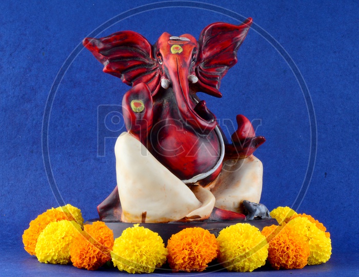 Hindu God Ganesha or Ganapathi. Lord Ganesha Idol on Blue Background