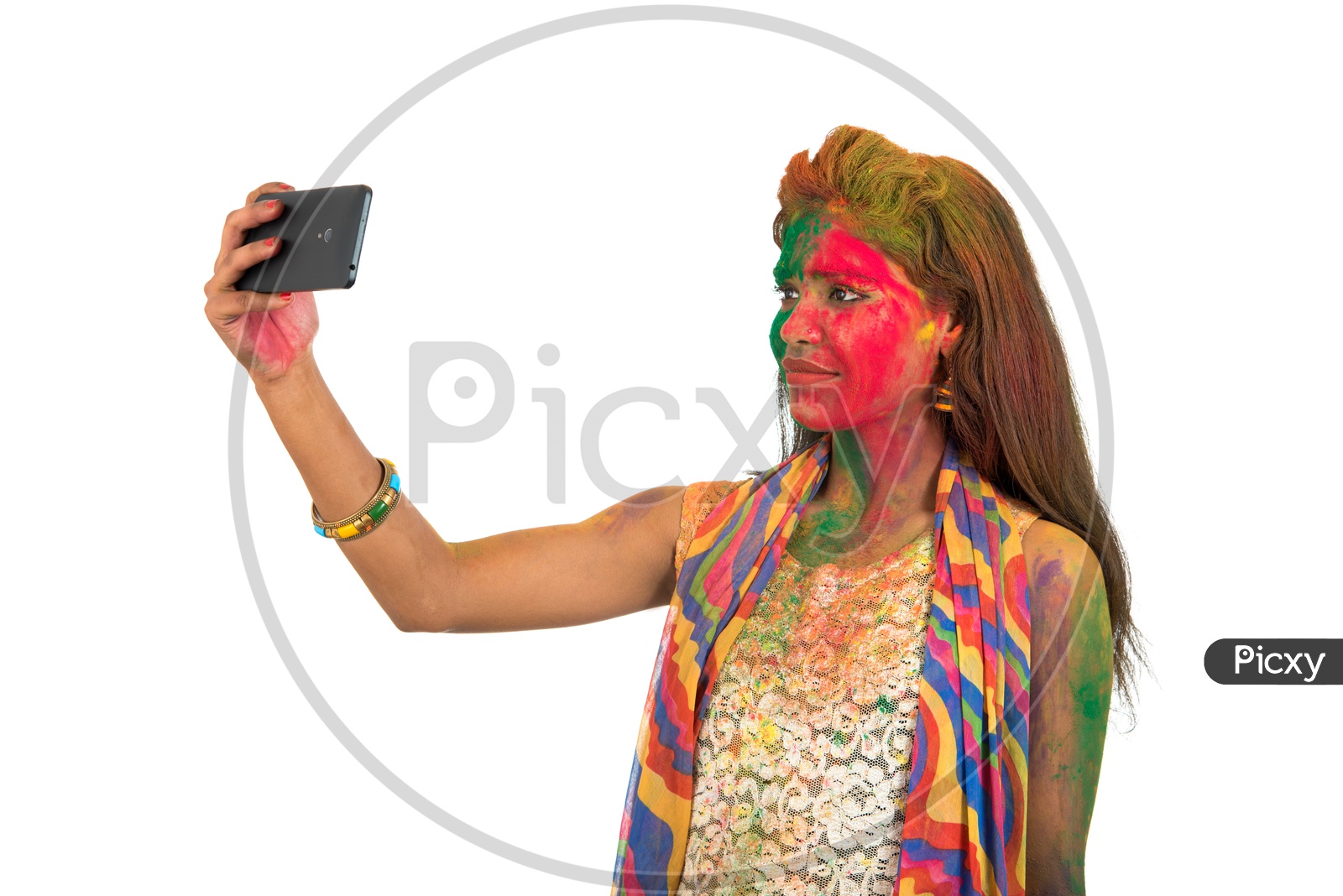 A Happy Young Indian Girl with Holi Colors On Her Taking Selfie With Smart Phone