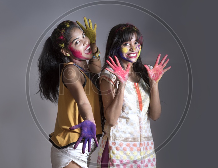 Young Indian Girls Showing Color Palms And Celebrating Holi