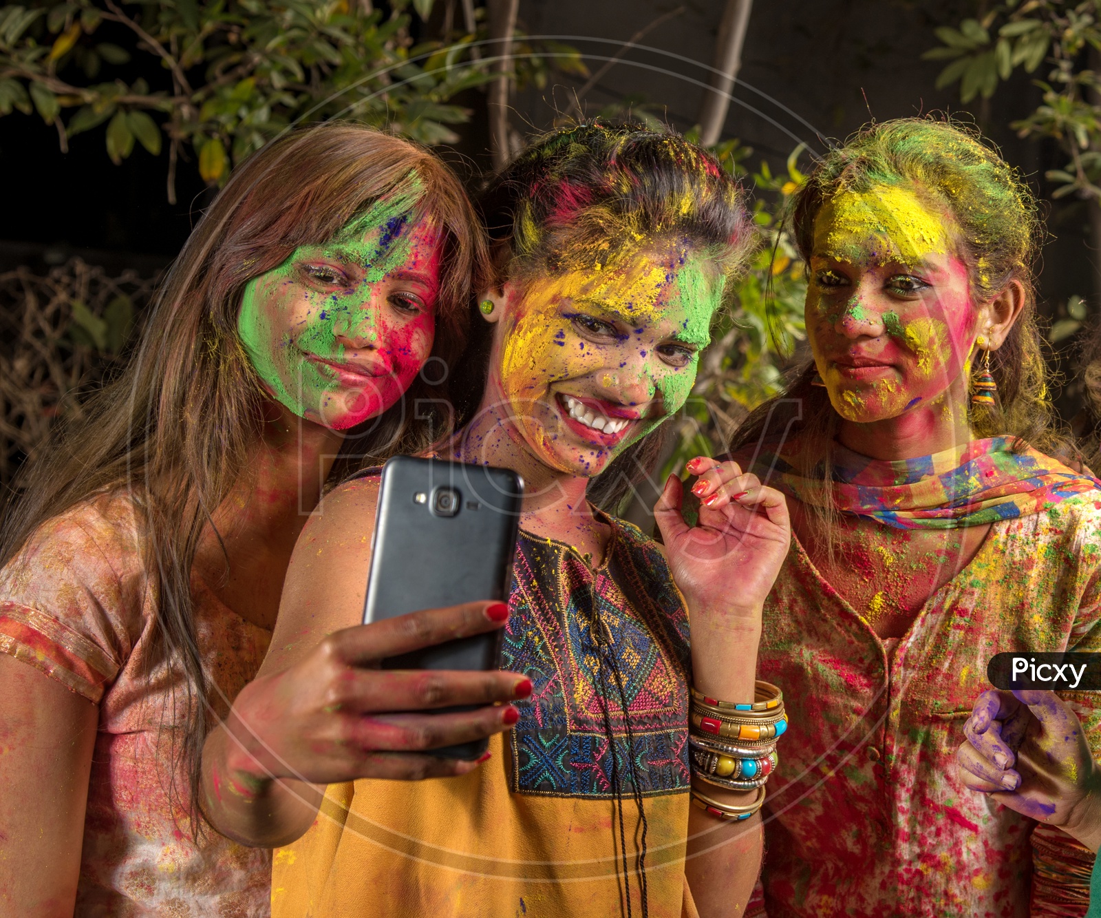 Group Of Young Girls filled In Holi  Colors Taking Selfie With Smart Phone
