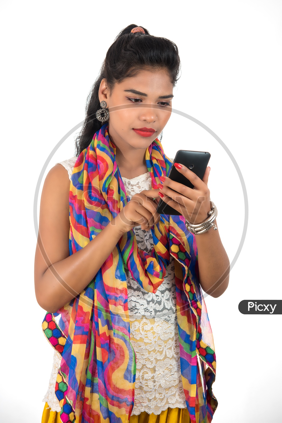 A Happy Young Indian Girl Using Smart Phone With a Smiling Face
