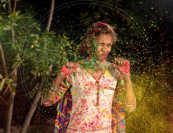 Young Indian Girl Happily Playing With Colors Celebrating Holi , Festival Of Colors