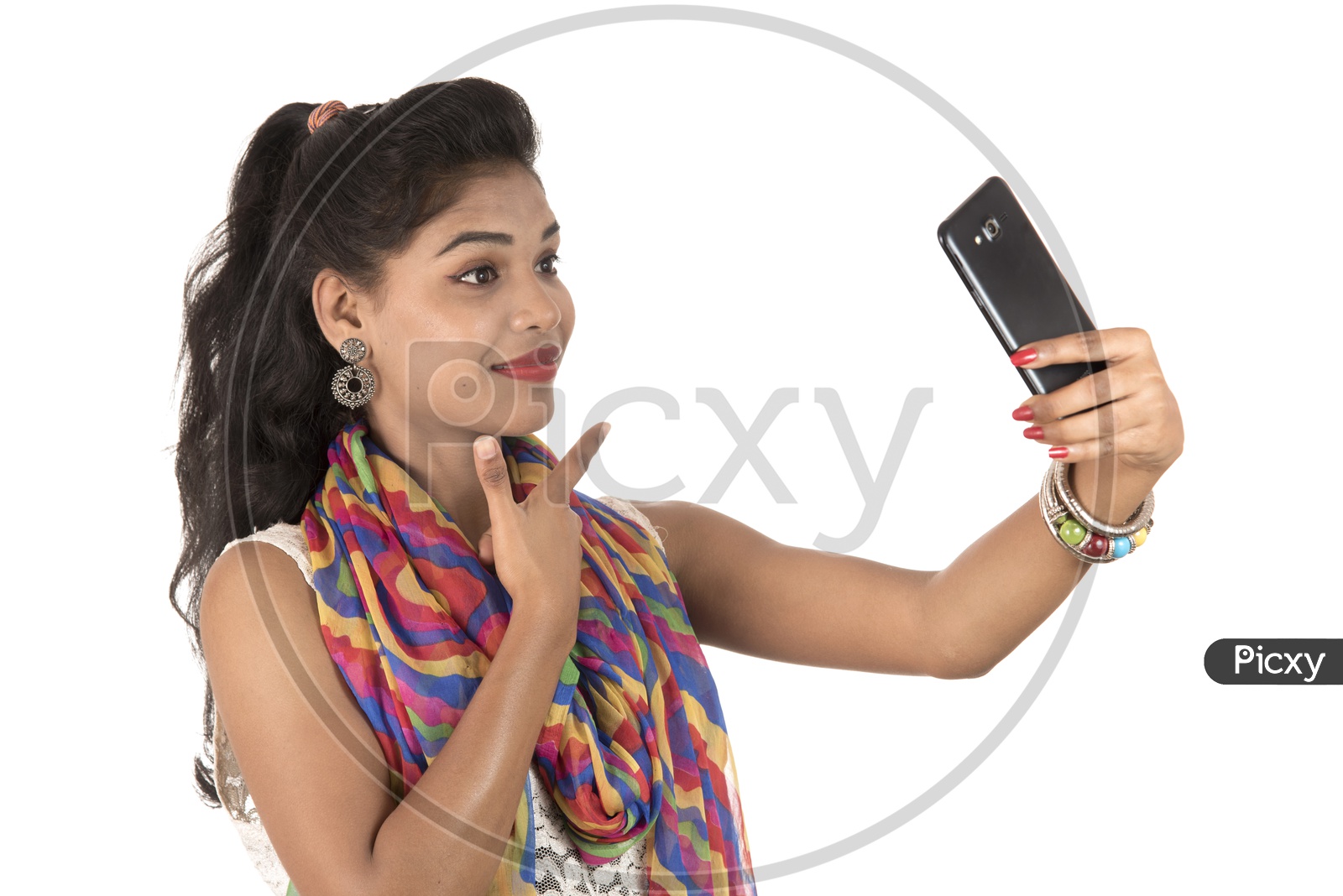 A Happy Young Indian Girl Taking Selfie With Smart Phone and Smile Symbol