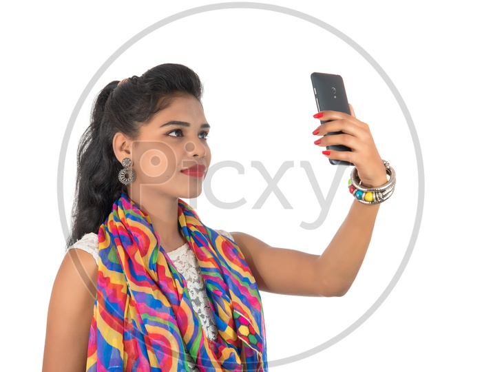 A Happy young Indian Girl Taking Selfie With Smart Phone