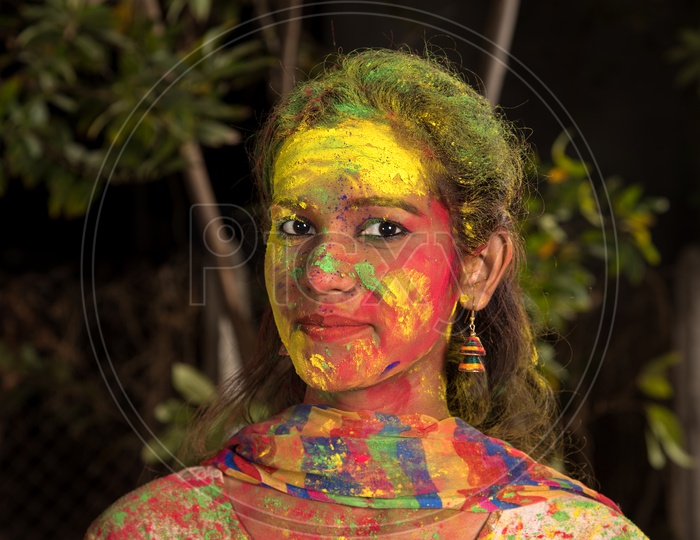 Portrait Of an Young Indian Girl With Holi Colors On Her and Posing