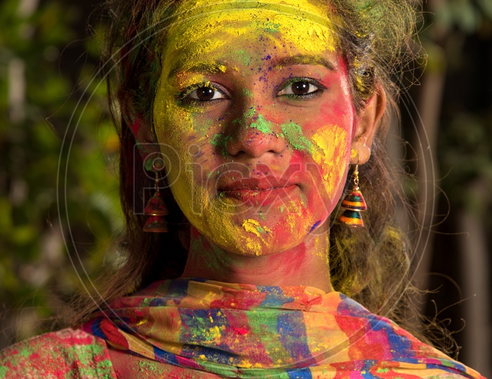 Portrait Of an Happy  Young Indian Girl With Holi Colors On Her and Posing