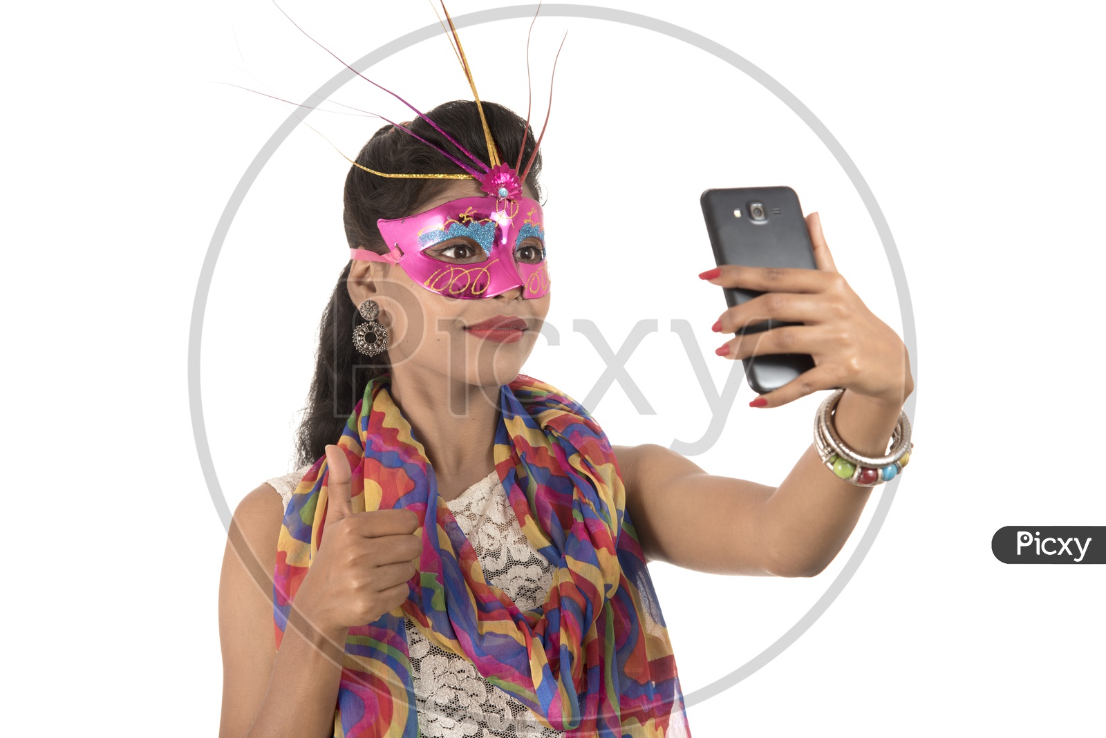Young Indian Girl Wearing Carnival Mask and Taking Selfie with Smart Phone