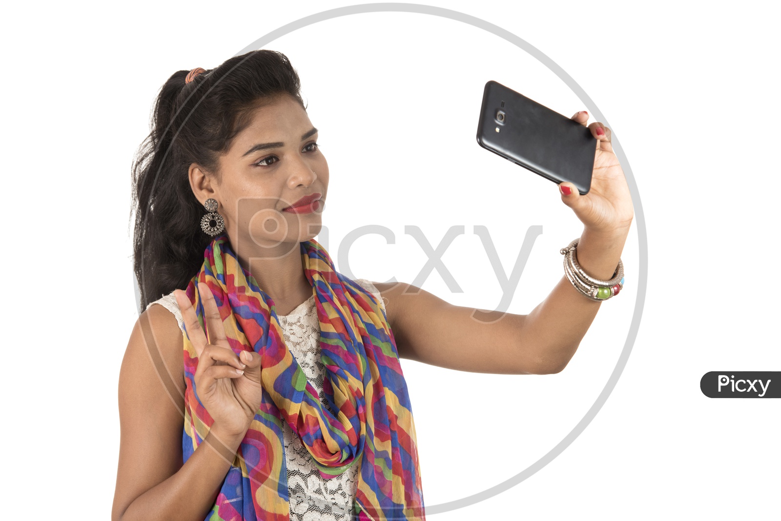 An Young Indian Girl Taking Selfie With Smart Phone And Showing Victory Symbol
