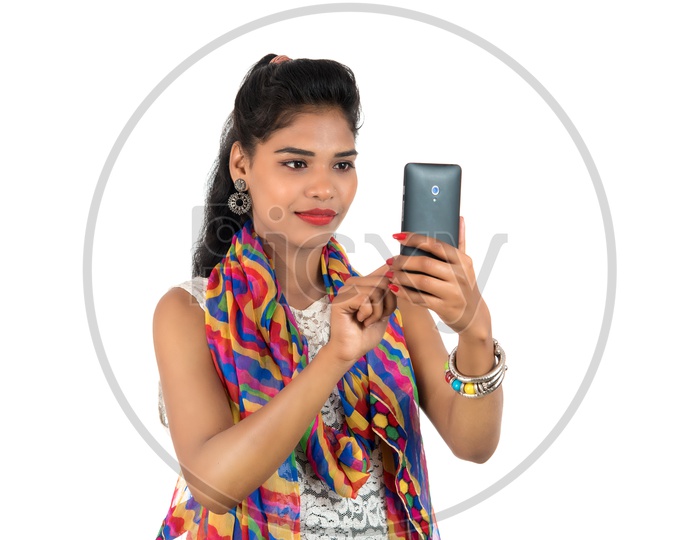 A Happy Young Indian Girl Using Smart Phone With a Smiling Face