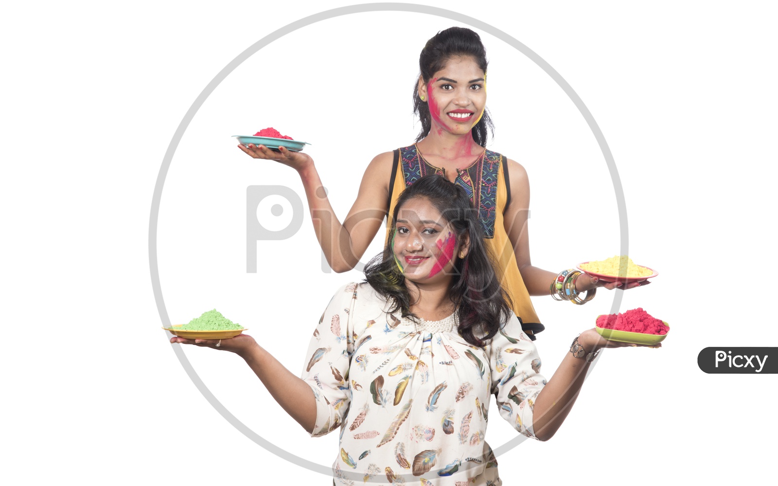 Young Indian Girls Holding Holi Color Plates and Celebrating Holi
