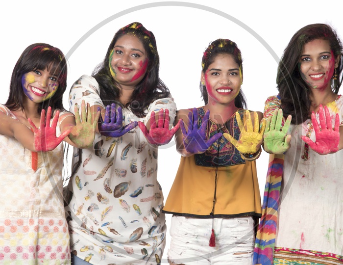 A Group Of Happy Young Girls Showing Color Palms And Celebrating Holi