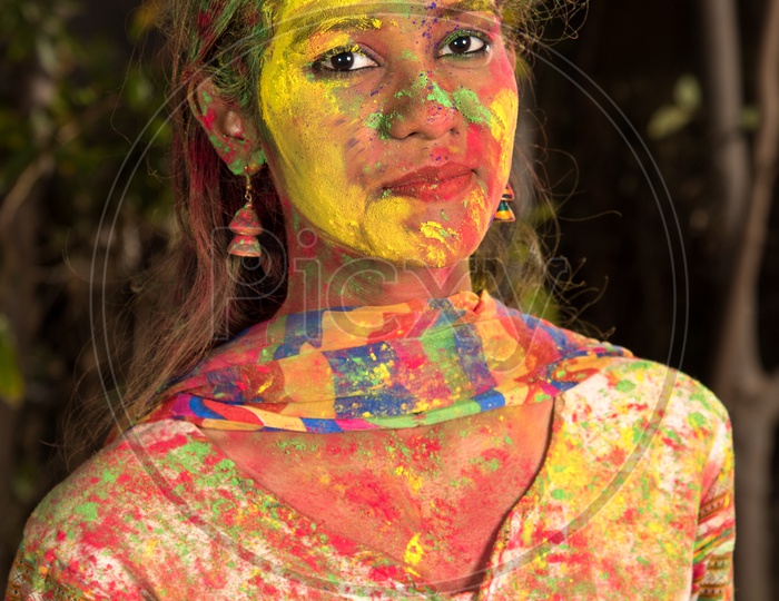 Portrait Of an Young Indian Girl With Holi Colors On Her and Posing