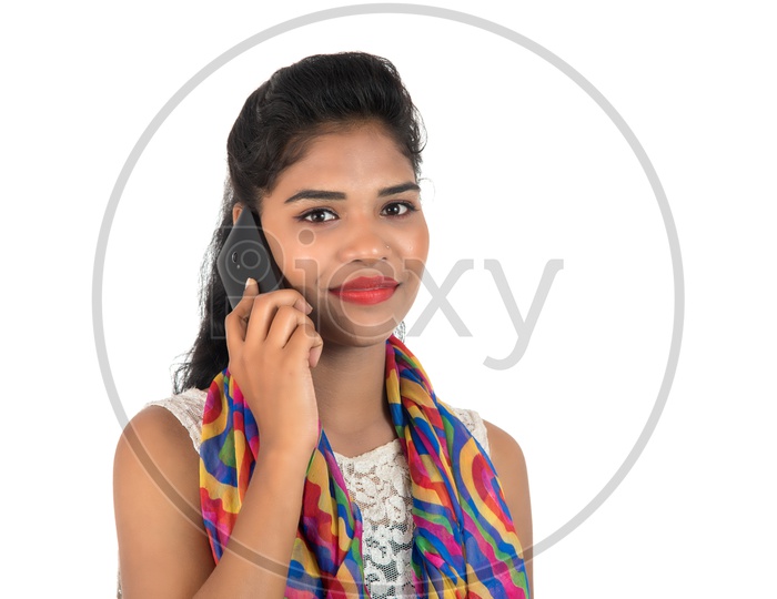 A Happy Young Indian Girl Talking In Mobile Phone With Smiling Face