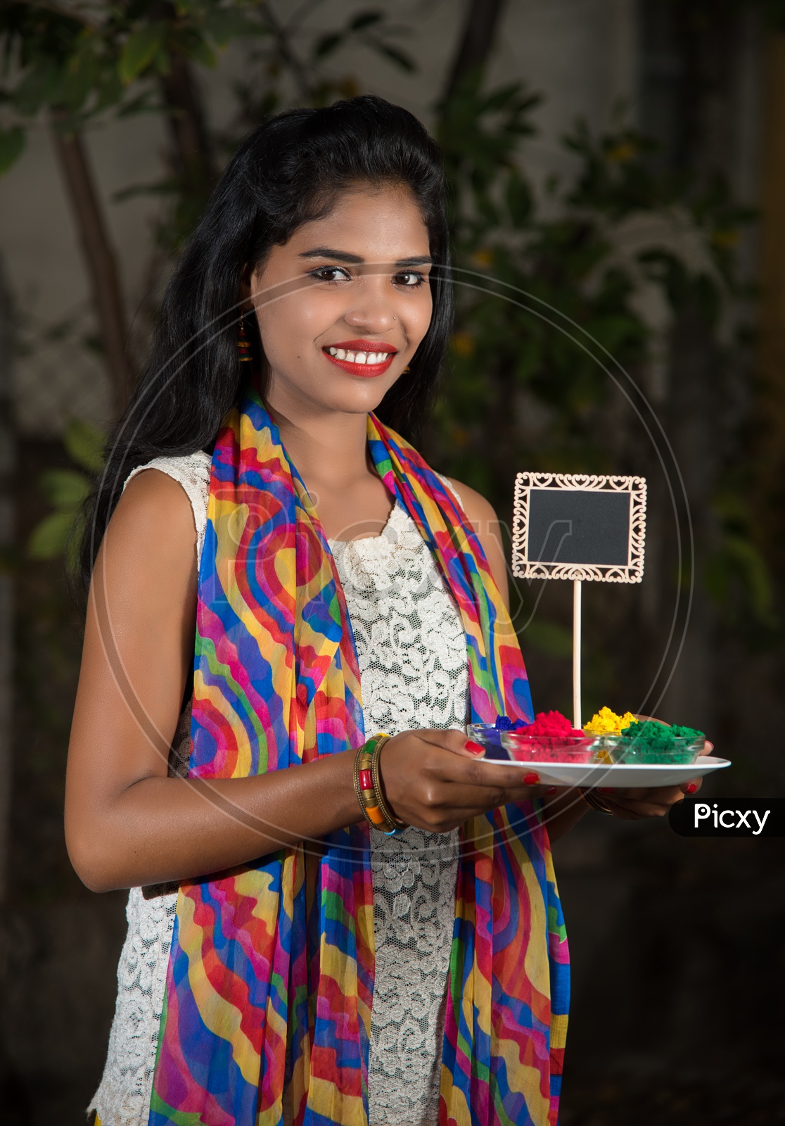 Young Indian Girl With Holi  Color Powder Plate In Hand With Smiling Face