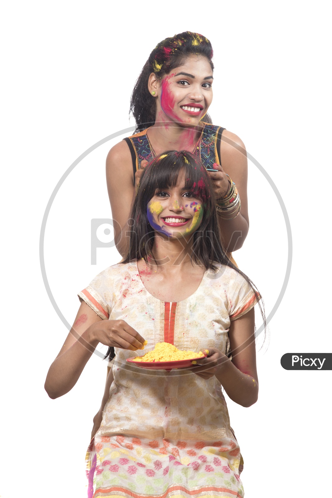 Young Indian Girls Holding Holi Color Powder Plates and Celebrating Holi