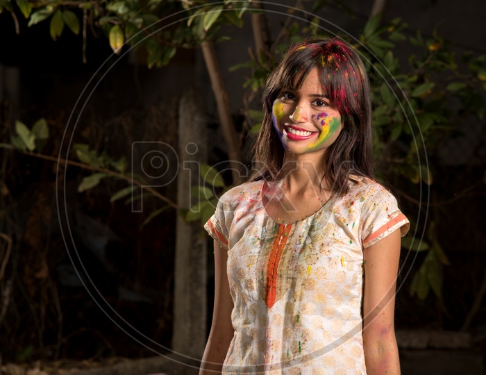 Portrait Of a Happy Young Indian Girl With Holi Colors On Her and Posing