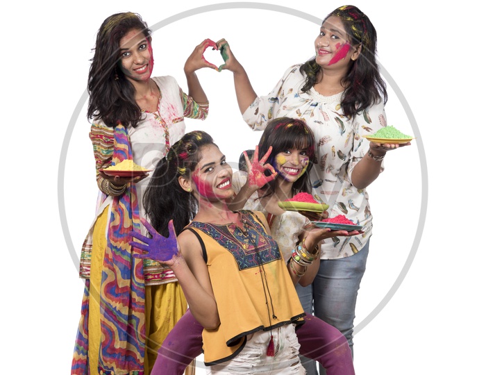 A Group Of Young Happy Girls With Holi Color Powder Plates And Celebrating
