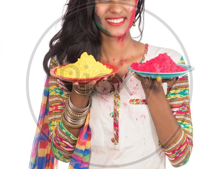 Happy Young Beautiful Girl Having Fun  With Colorful Powder Plate  at Holi Festival Of Colors