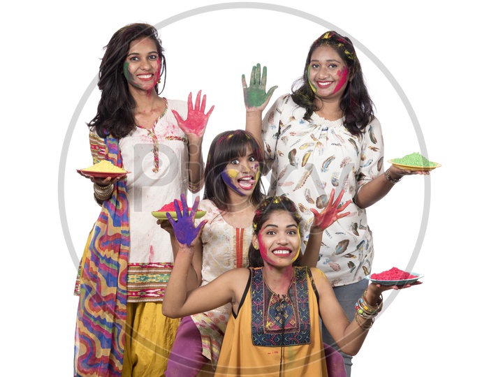 A Group Of Young Happy Girls With Holi Color Powder Plates And Celebrating