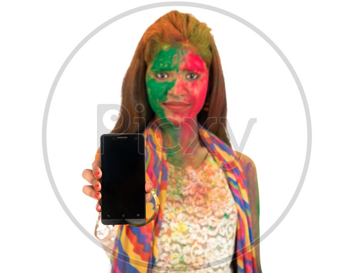 Young Indian Girl Filled In Holi Colors And Showing  a Smart Phone