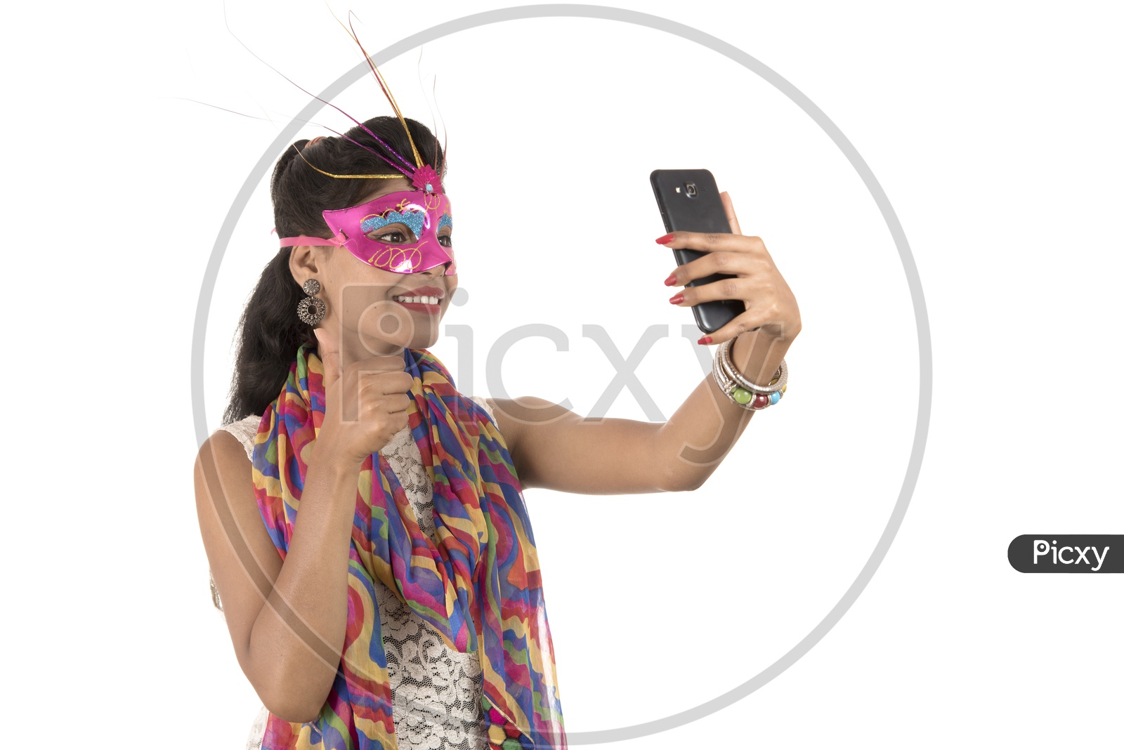 Young Indian Girl Wearing Carnival Mask And Taking Selfie in  Smart Phone