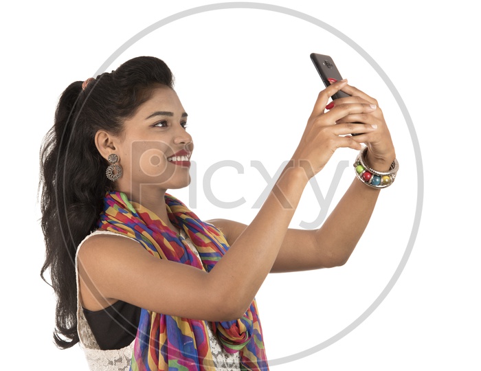 A Happy Young Indian Girl Taking Selfie With Smart Phone