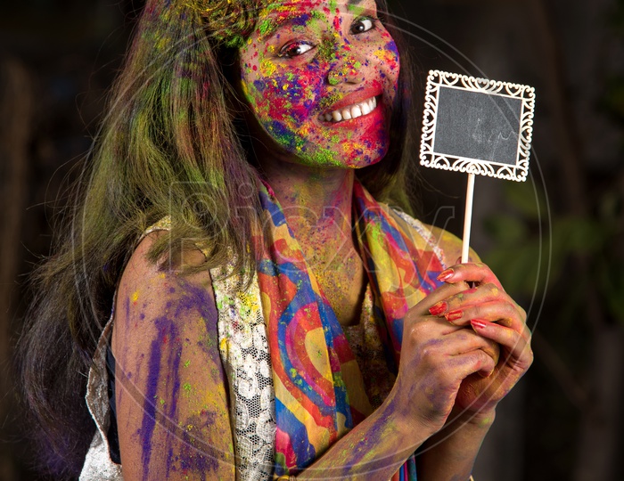 Young Indian Girl Celebrating Holi With Placard In Hand