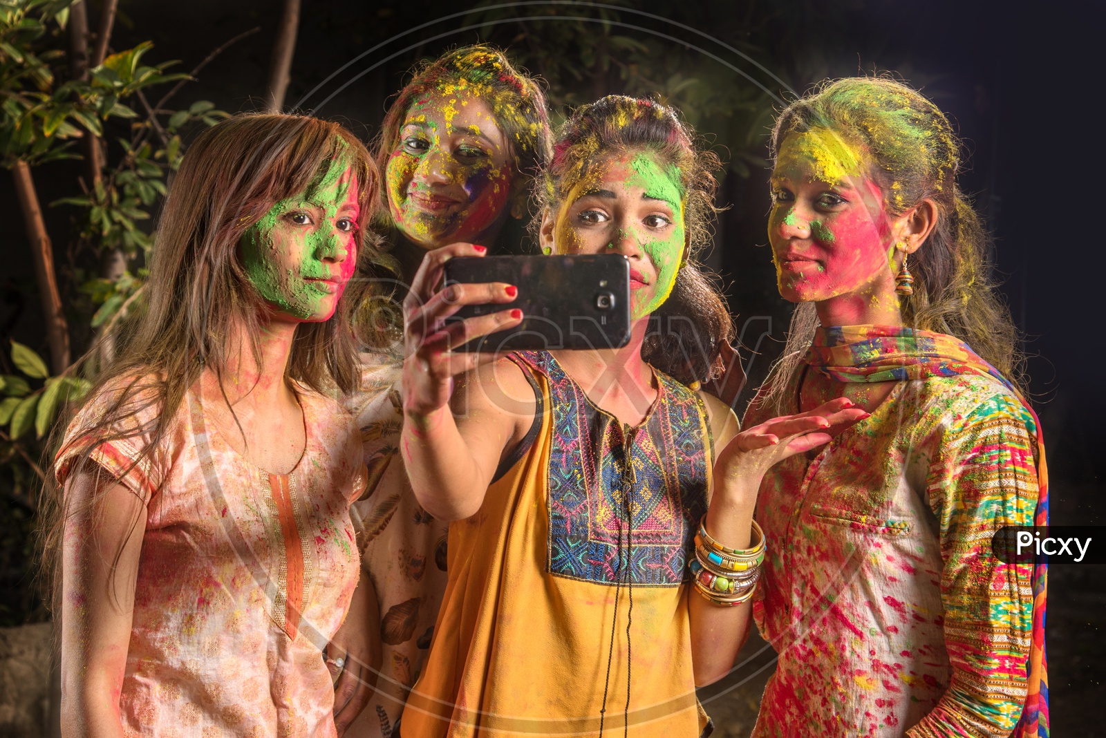 Image of A Group Of Young Girls Filled In Holi Colors and Taking A ...