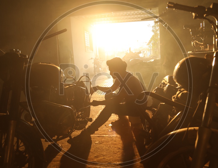 Silhouette Of a Bike Mechanic Working In  a Workshop