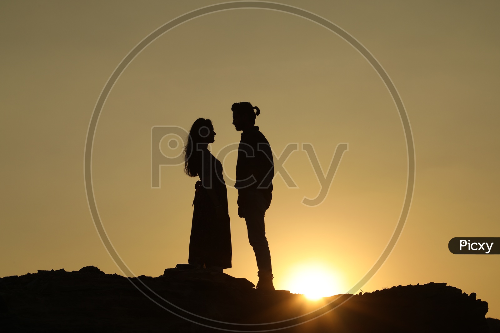 Silhouette  of a couple with sun in background