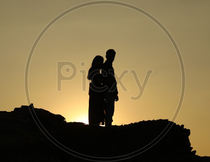 Silhouette of a couple with sun in background