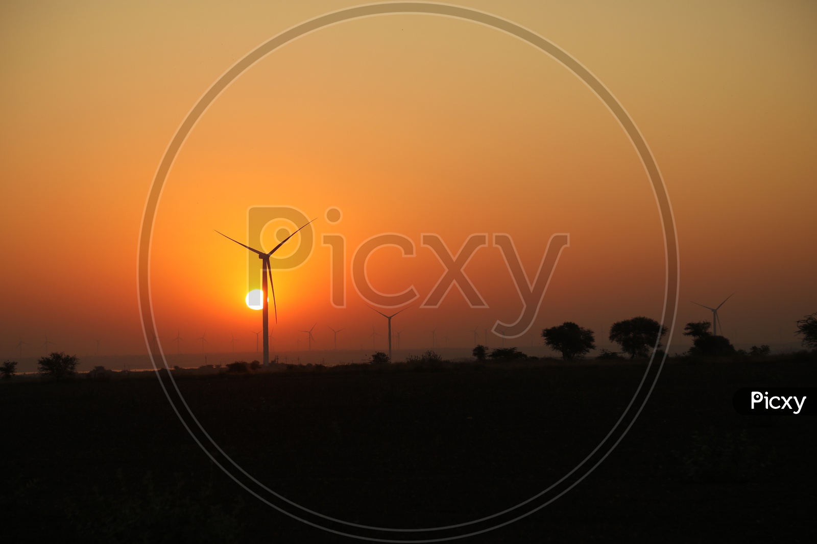 Wind mill with sunset in the background