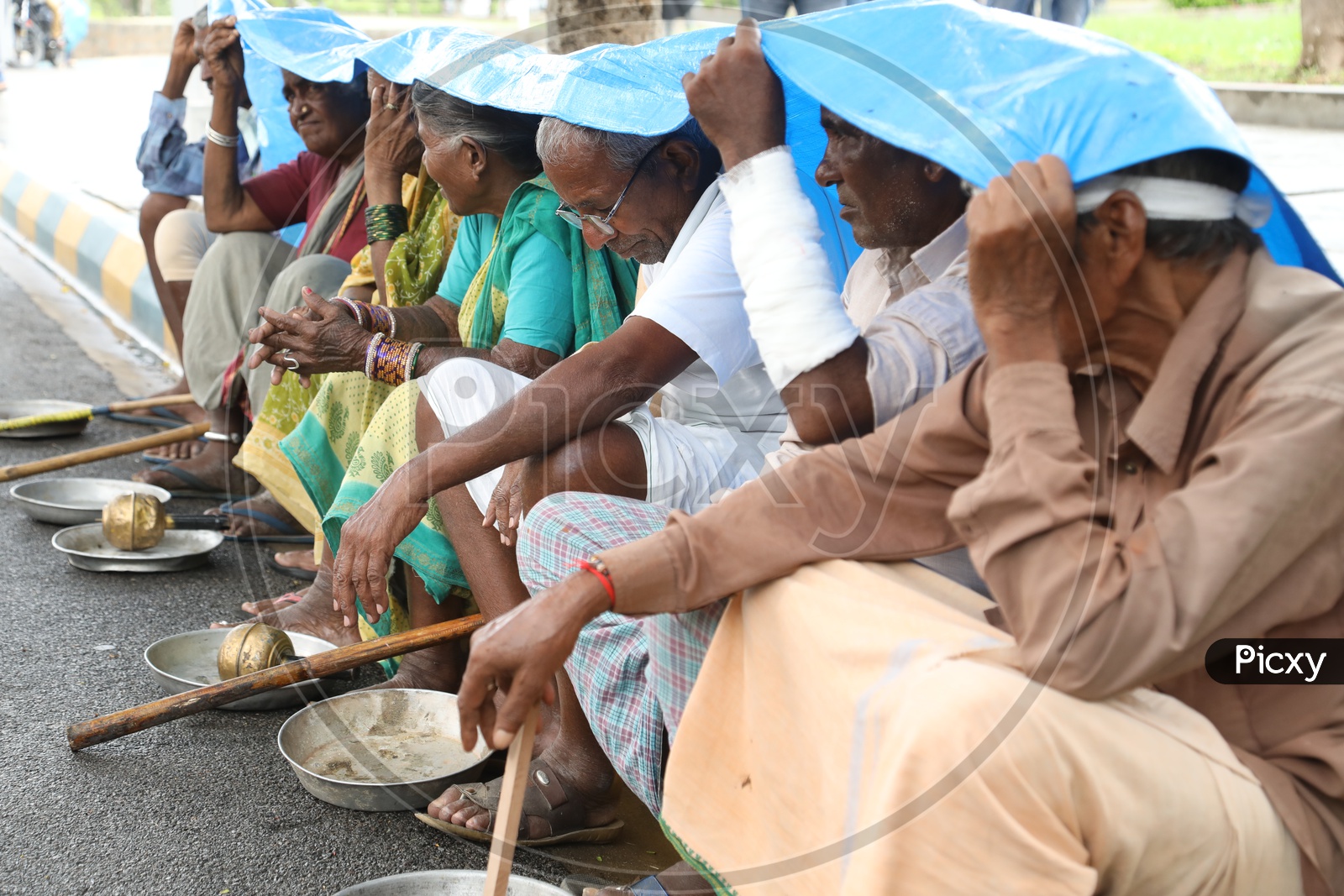 Beggars Sitting On Road Side Platform