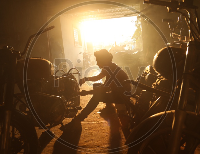 Silhouette Of a Bike Mechanic Working In  a Workshop