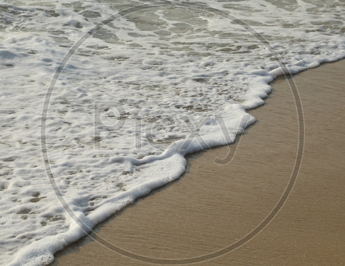 Water wave on beach sand