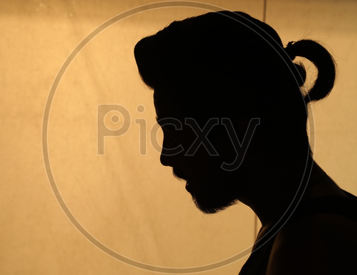 Silhouette Of A Man Over a Golden light Background