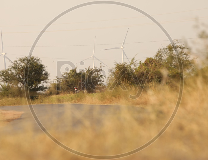 Dry steep grass on the roadside - Biker out of focus