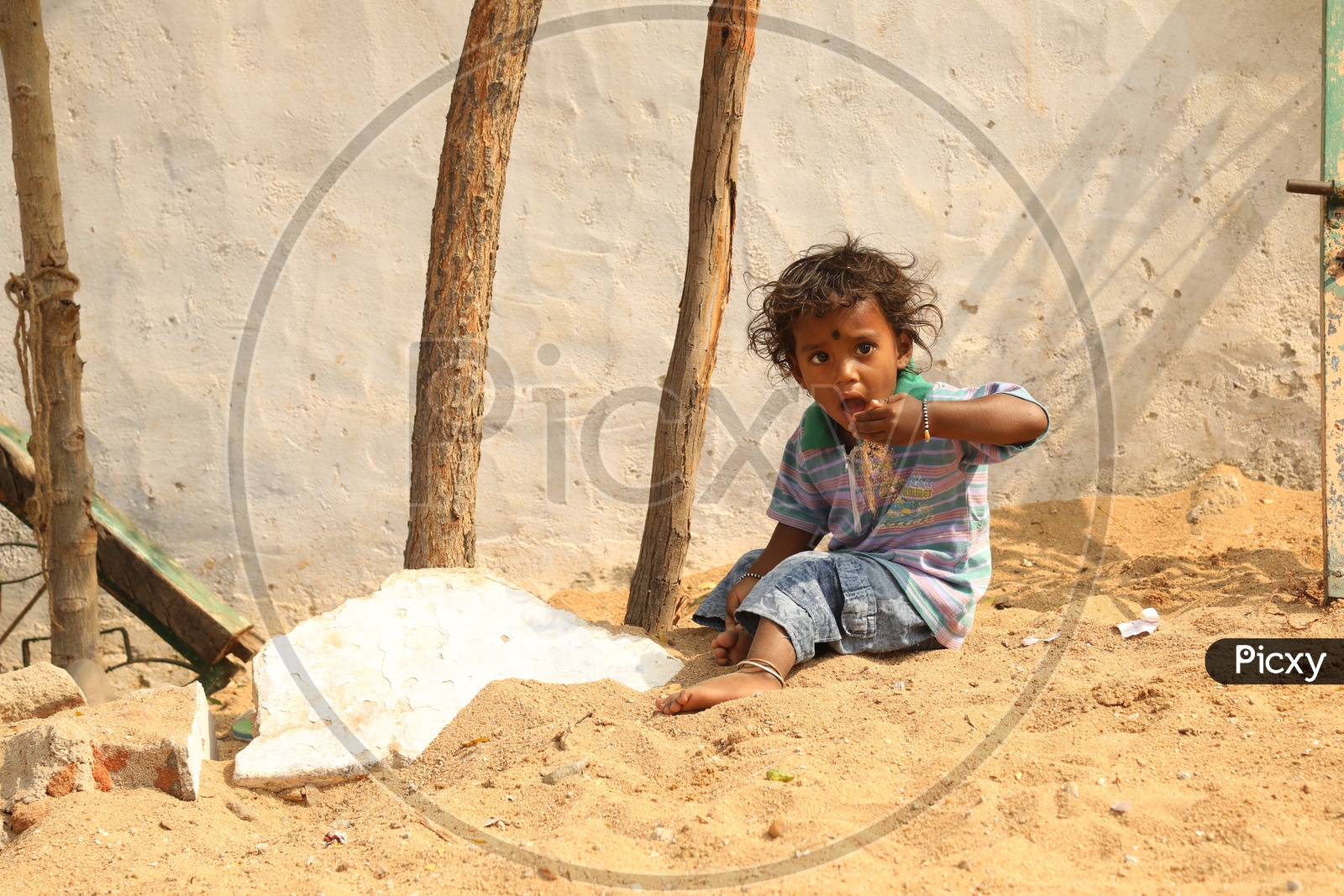 A Girl child playing with the sand