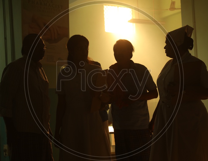 Silhouette Of Nurses And Patients in a Hospital Room