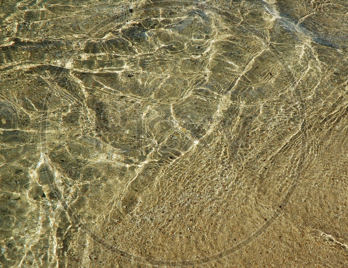 Transparent water  surface on sand
